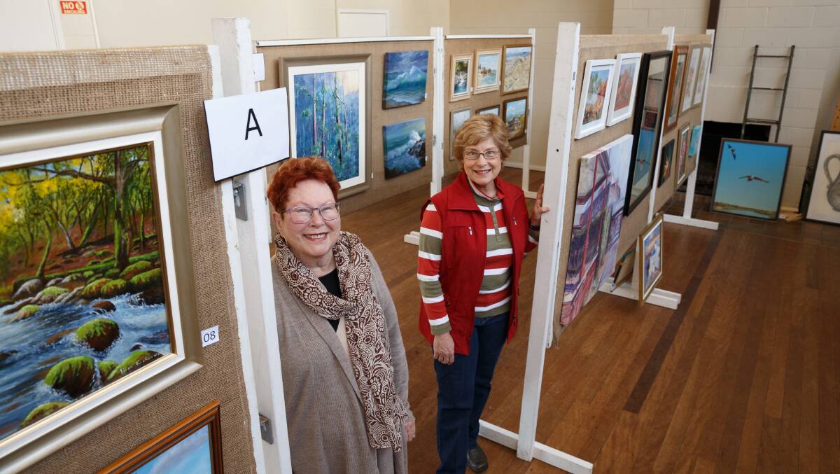 ART STARTER:  Maitland Region Society of Artists president Verona Lucas and curator Joanne Conder get ready for the weekend's big exhibition. Picture: Max Mason-Hubers.