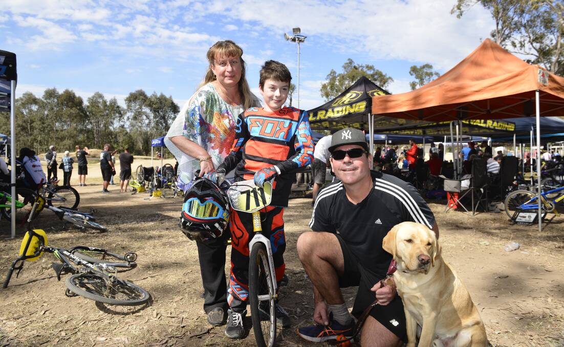 Dashing debut: Ten-year-old Noah Johns at his first BMX competition on the weekend, with mother Melinda, father Paul and guide dog Keith.   