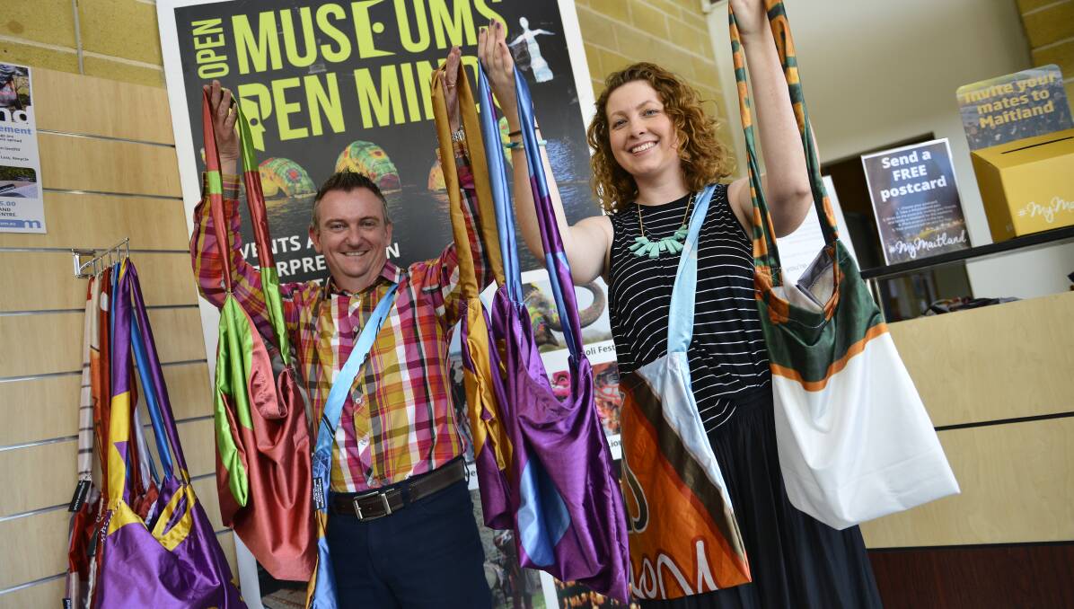 Trashion statement: Maitland Council's Matt vanderWall and Kate Henry with a selection of the recycled bags at the Tourist Information Centre on Wednesday. Picture: Lachlan Leeming. 
