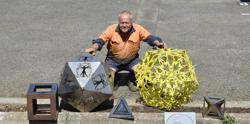 Stolen: Bill Cummins with a collection of his metal artwork ahead of an exhibition. The stolen piece is under his right hand. Picture: Lachlan Leeming 