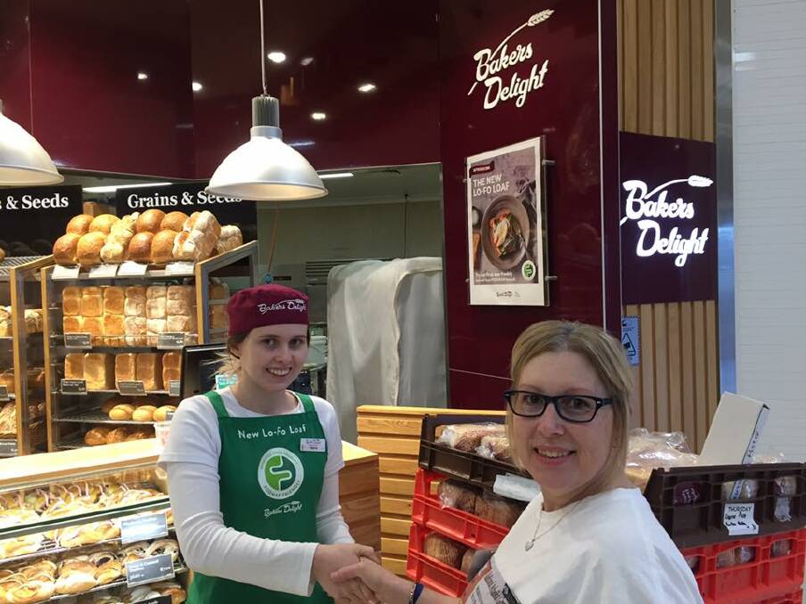 Generous donation: Rachel Parson with a Bakers Delight staff member. Picture: supplied. 