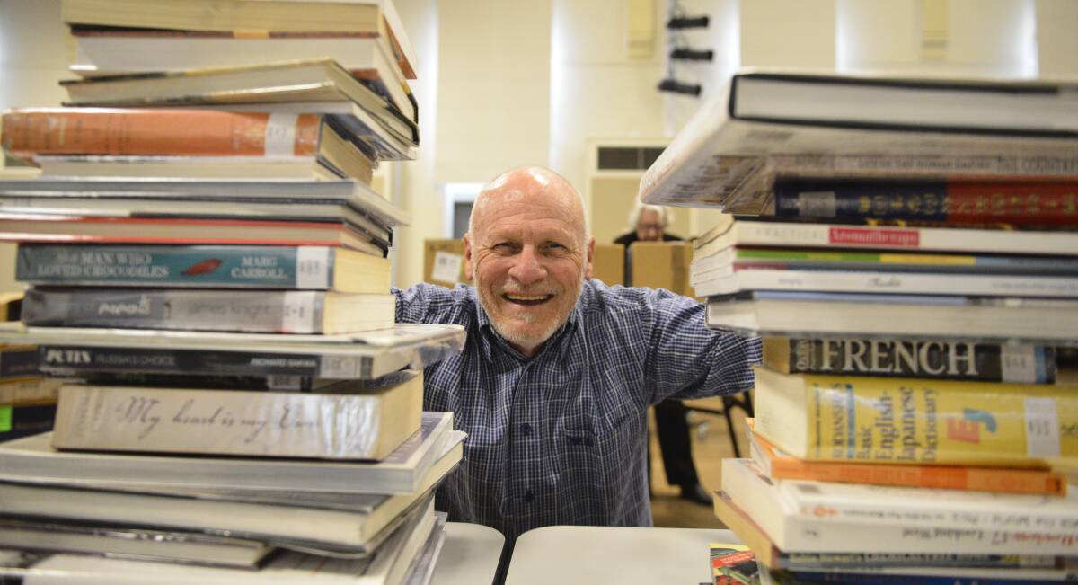 Something for everyone: Friends of Maitland Library's John Brown is encouraging residents to turn the pages at the library's annual book sale. Photo: Lachlan Leeming. 
