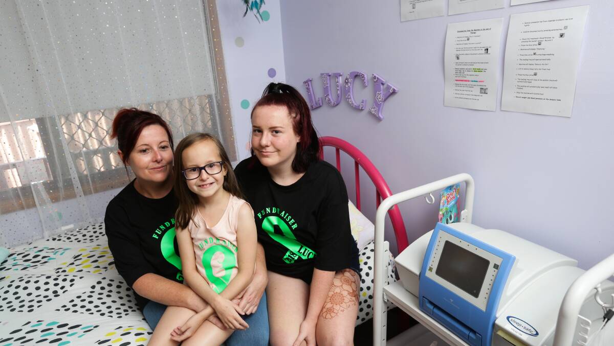  Lucy, Leigh and Lily next to Lucy's dialysis machine, which she spends 14 hours a night hooked up to. 