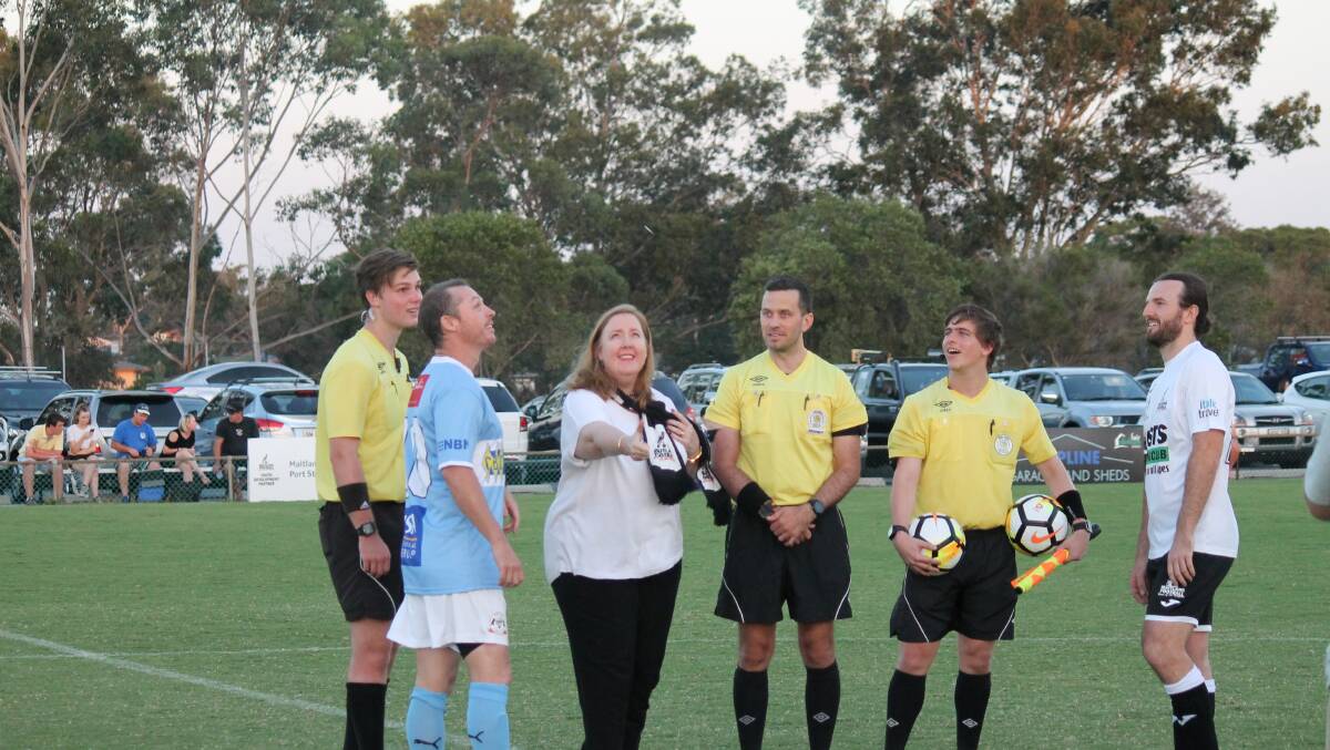 Running into the wind: Maitland MP Jenny Aitchison tosses the coin before the Weston and Maitland match last weekend. 