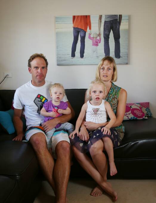 IN SHOCK: Dave and Gabby Robertson, of Wickham, with daughters Emma, 10 months, and Grace, 3. Picture: Max Mason-Hubers