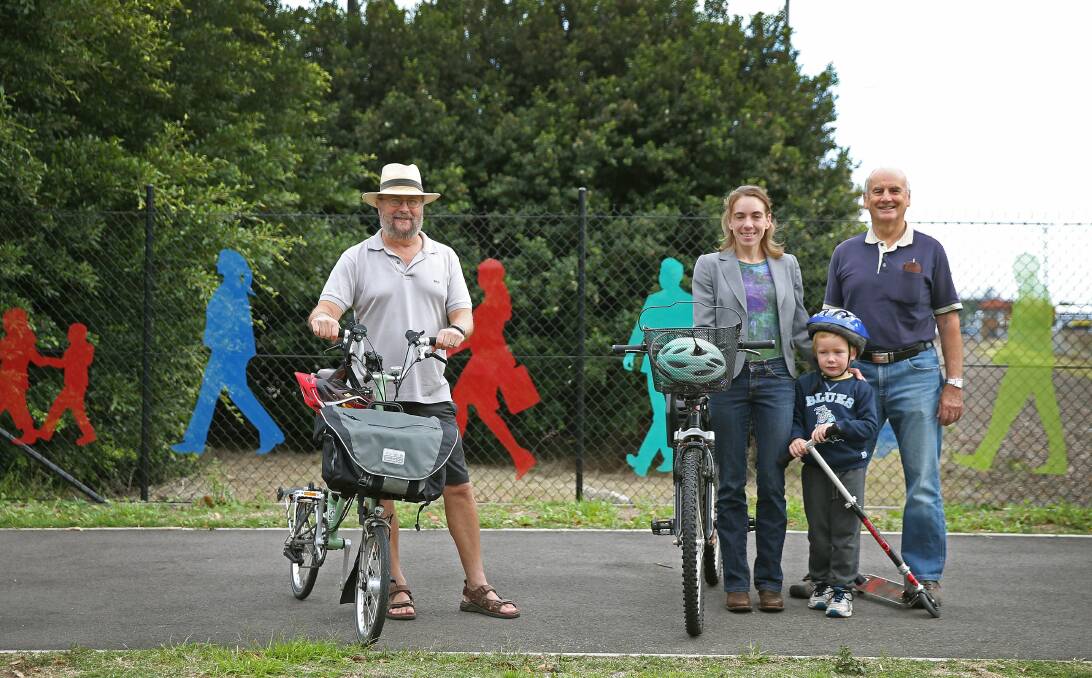 On track: CycleSafe supporters Sam Reich, Megan Sharkey, and Tim Roberts, with four-year-old Zeb, want the state government to build a network of linked pathways throughout Newcastle and Lake Macquarie. Picture: Marina Neil.
