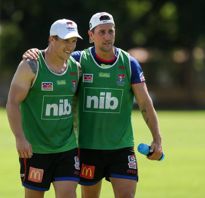 On the move: Trent Hodkinson sharing a moment at Knights training with Mitchell Pearce. Picture: Max Mason Hubers