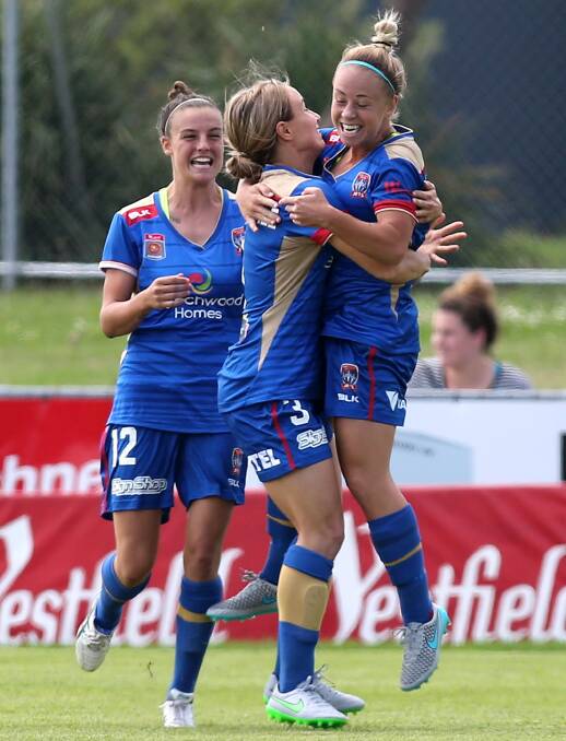 FLYING HIGH: Jenna Kingsley (far right) celebrates a goal for the Newcastle Jets. She joins W-League teammate Cassidy Davis at Lochinvar on Saturday.