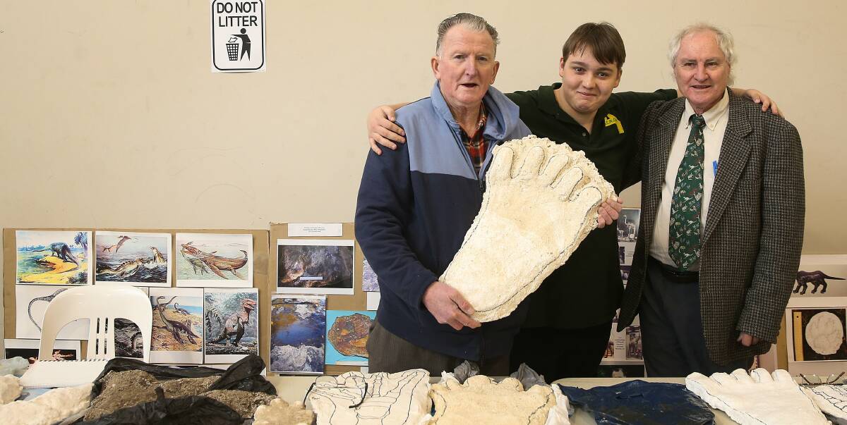 I WANT TO BELIEVE: Rex Gilroy, Jack Tessier and Gary Opit surrounded with alleged plaster-cast Yowie footprints at the convention. Picture: Marina Neil