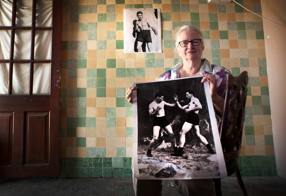 COMING SOON: Accommodation founder Liz Berger poses with posters of boxing legend Les Darcy in the front bar of the old Currency Lass pub. It will re-open as a cafe next month. Picture: Perry Duffin