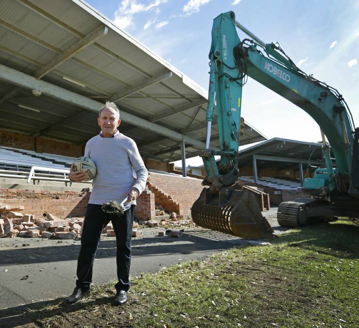 MOVING AHEAD: Pickers legend Terry Pannowitz takes a brick as a memento from his grandstand as demolition begins. Picture: MARINA NEIL