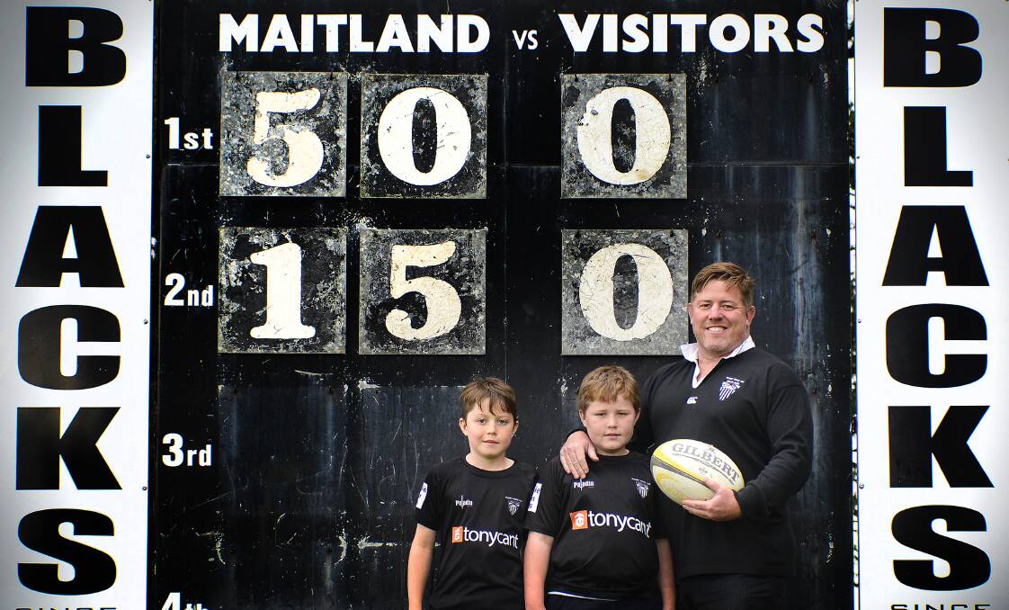 PROUD BLACKS: Ben Emmett, with sons Patrick and Darcy, plays his 150th grade game for the Maitland Blacks and 514th game all up on Saturday.