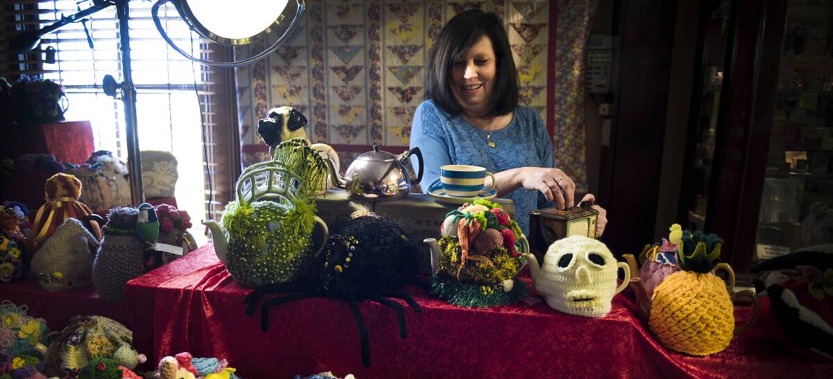 TEA PARTY: Campbell's Store team member Sue Jarrett surrounded with the myriad of bizarre teapot and tea cosy designs that will be exhibited. Picture: PERRY DUFFIN