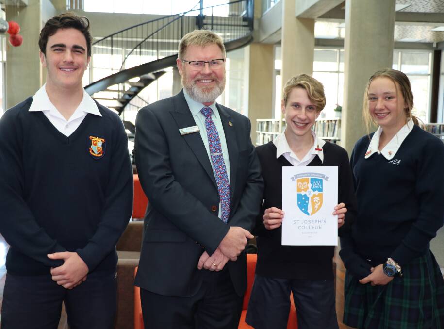 NEW LOOK: Harry Whitfield, Principal Paul Greaves, Patrick Macindoe and Brianna Redding unveiling  St Joseph's new crest and name this week.