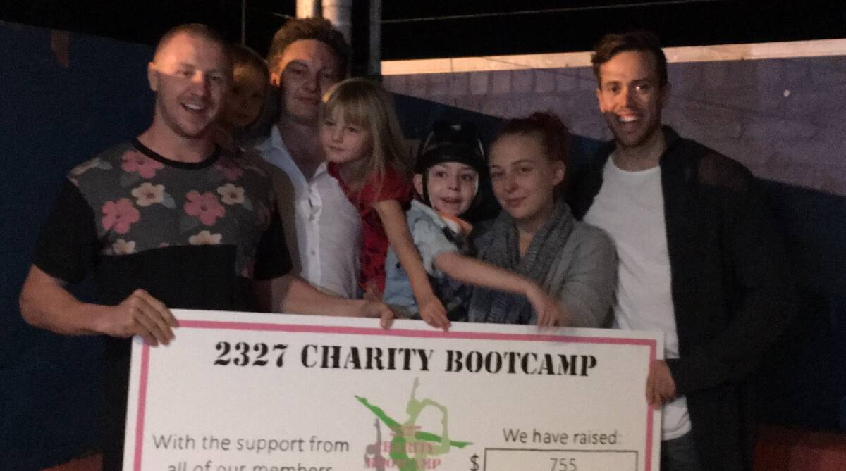 STEPPING UP: 2327 Bootcamp owner and trainer Jayme Richardson (far left) and Mitchell Done (far right) with Kody and his family. Picture: SUPPLIED.