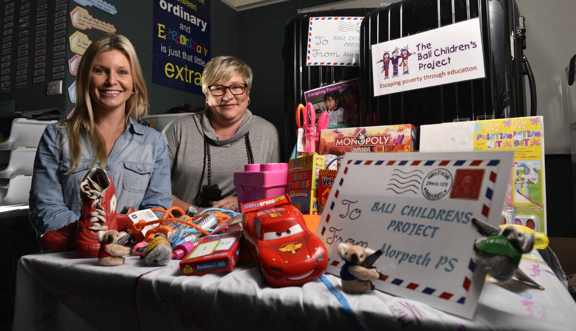DONATIONS: Jess Stevens and Suze Touzell at Morpeth Public School with the numerous gifts, toys and resources donated by the students for the Bali Children's Project. Picture: PERRY DUFFIN