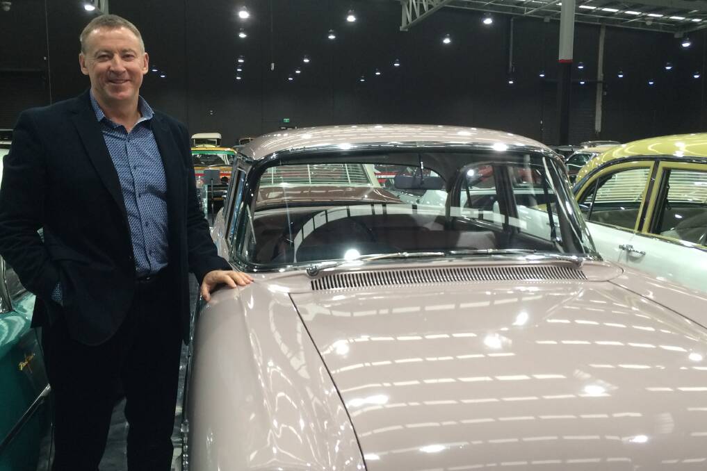 Enthusiast: Tony Denny beside a powder pink Holden EK Special from 1961, similar to the car he learnt to drive in.