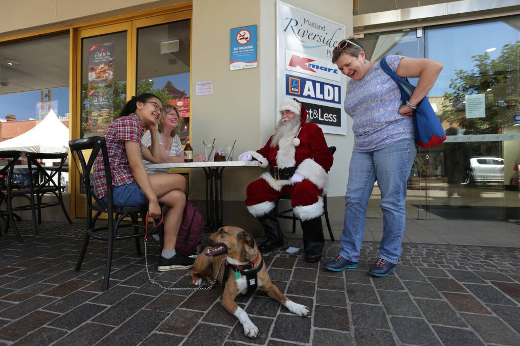 JOLLY: Santa having a chat with from left Lucy Shi, Sandy Wagner, Sarah Foster and Hector the dog. Picture: Simone De Peak
