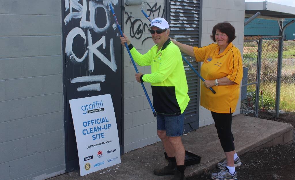 WELL DONE: Chris Osman and Dianne Simmons working hard at Telarah station on Graffiti Removal Day.