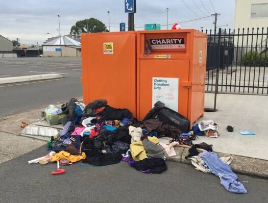 OVERFLOWING: The charity bins in central Maitland on Thursday, with donations scattered around the car park. Picture: Betina Hughes
