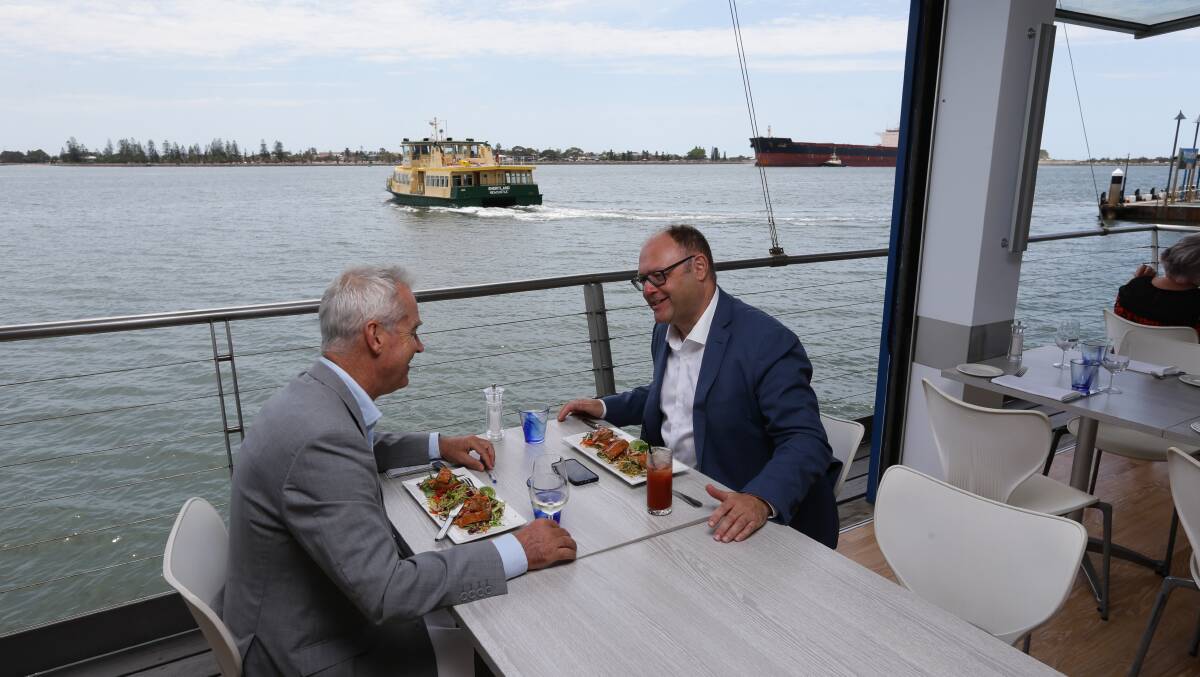Jim Bentley at lunch, with harbour life in the background. Picture: Jonathan Carroll