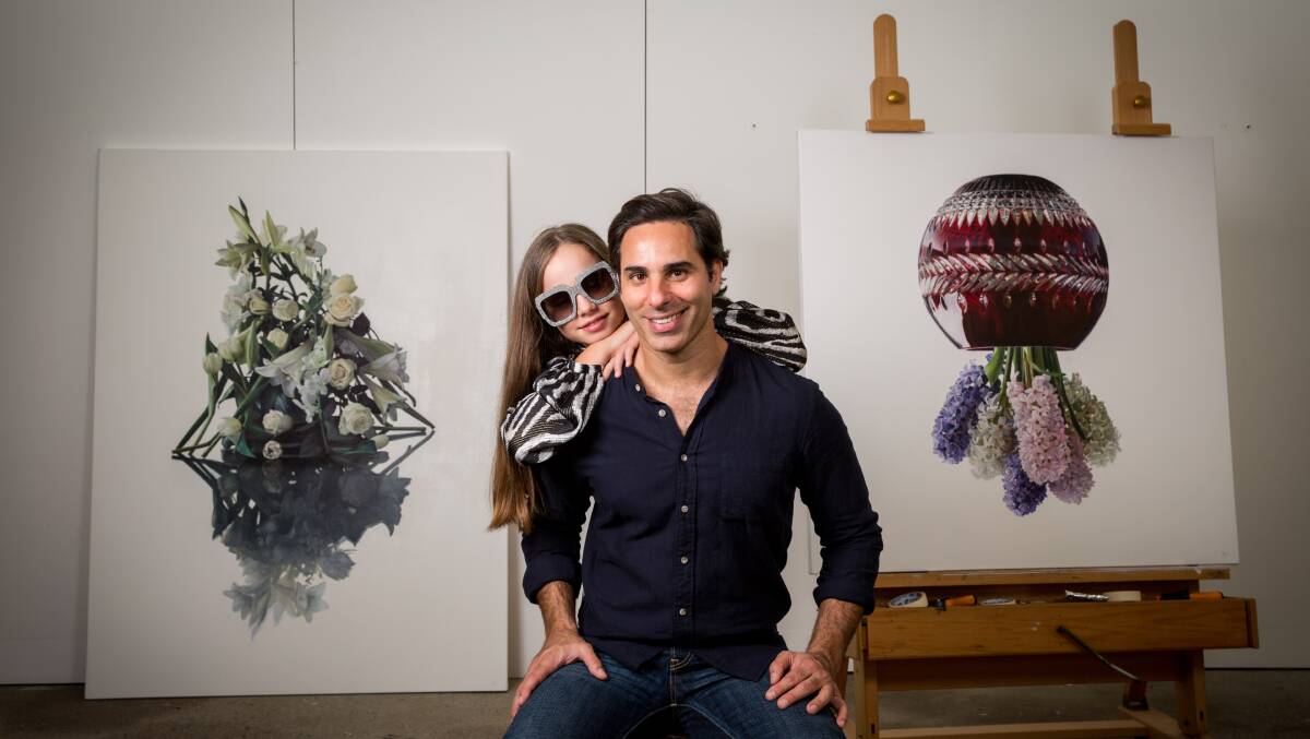 FAMILY PORTRAIT: Michael Zavros in his Brisbane studio last year with daughter, and frequent portrait subject, Phoebe. Picture: Paul Harris 
