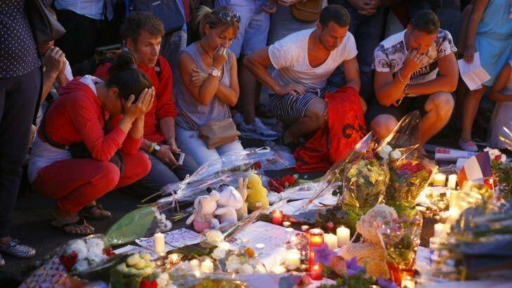 People pay homage to the victims at a makeshift memorial in Nice. Photo: Francois Mori