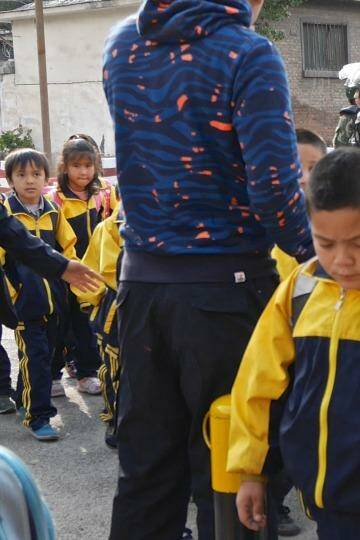 Children leave school under armed guard in Urumqi. Photo: Sanghee Liu