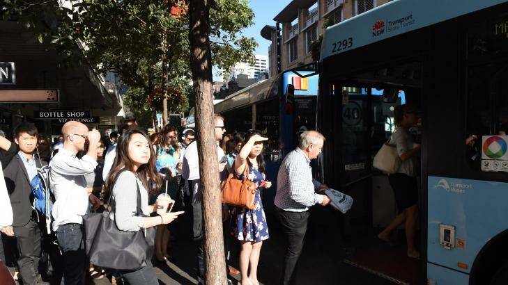 Commuters board a bus on the corner of Park and Elizabeth streets. Photo: Nick Moir