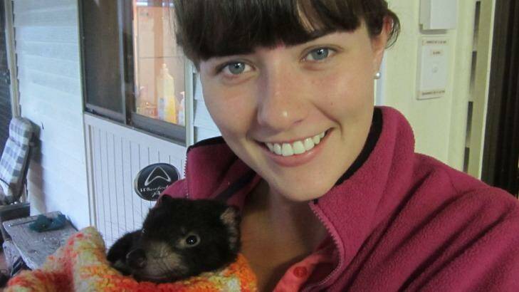 Biologist Emma Peel with a young Tasmanian devil. Photo: Emma Peel