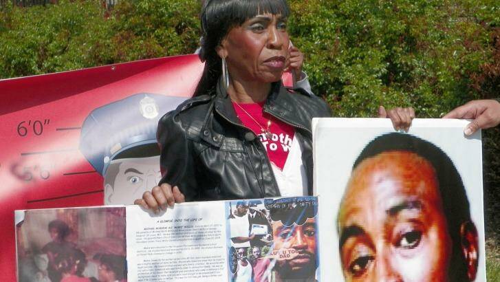 Alice Willis holds a photo of her son, Michael Willis, In New York to show support for Baltimore demonstrators and call for more input by blacks into police operations. Photo: Jim Salter