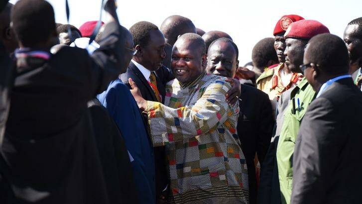 Former Vice-President Reik Machar is greeted by officials after touching down in Juba. Photo: Kate Geraghty