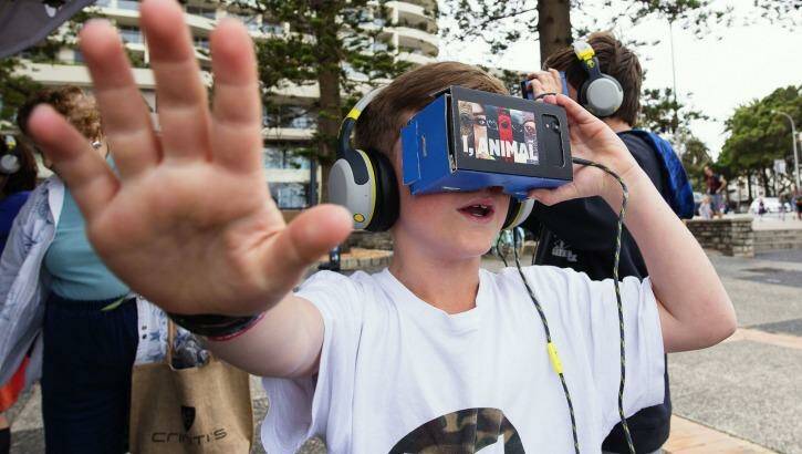  Nick and Ben Layton using iChicken virtual reality gear at Manly Wharf. Photo: Christopher Pearce