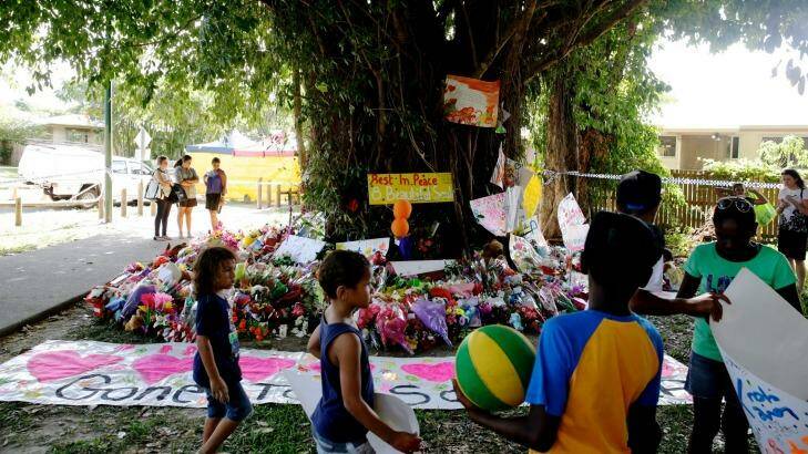 Children leave paintings and toys at a tree near the house in Cairns. Photo: Edwina Pickles