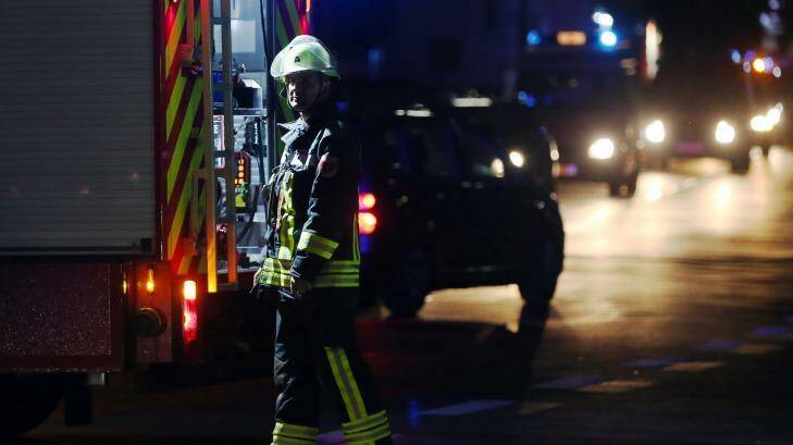 A firefighter stands at a road block in Wuerzburg after a man attacked people on a train. Photo: Karl-Josef Hildenbrand/AP