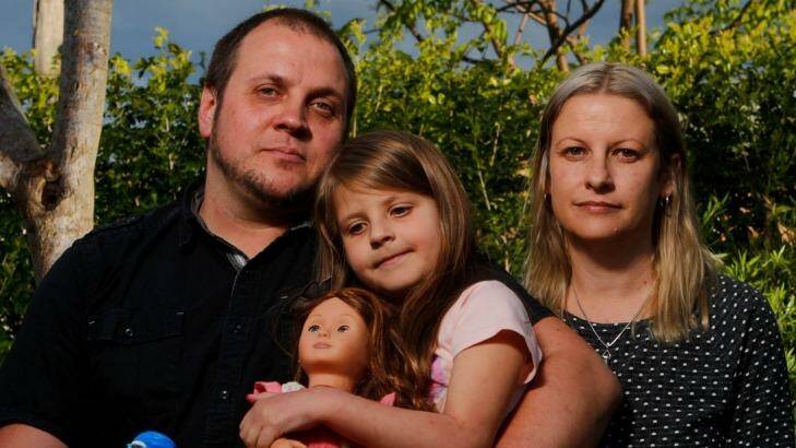 Martin Schmidt with daughter Chloe and wife Karina Schmidt. Chloe's mood and behaviour dramatically changed when she started taking Montelukast. Photo: Adam McLean AMZ