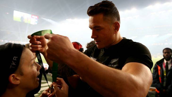 Touching gesture: Sonny Bill Williams hands his medal to young fan Charlie Line. Photo: Getty Images 