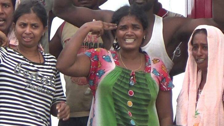 One Tamil woman mimes shooting herself before the Sri Lankans were permitted ashore Photo: Fadly