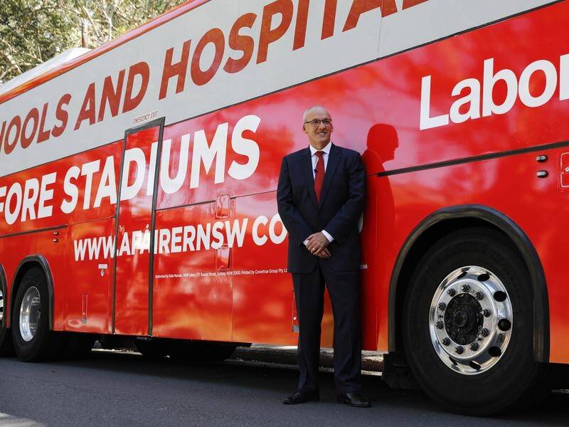 NSW Opposition Leader Luke Foley in front of his 'Schools and Hospitals Before Stadiums' bus.