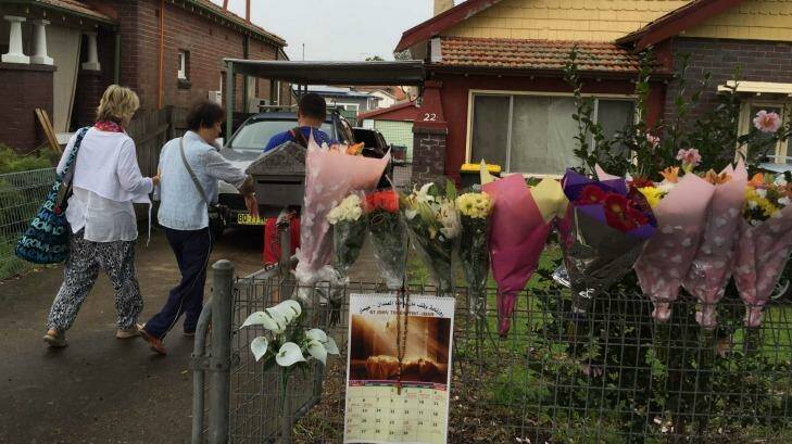 Bouquets of flowers line the fence of the Chans' house in Enfield as Michael and Helen Chan arrive home from Indonesia. Photo: Melanie Kembrey