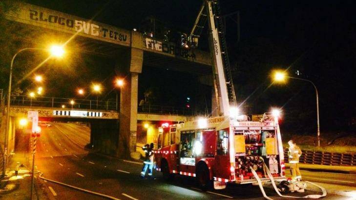 NSW Fire & Rescue workers at the scene of the train on fire at Granville on Tuesday night. Photo: NSW Fire & Rescue