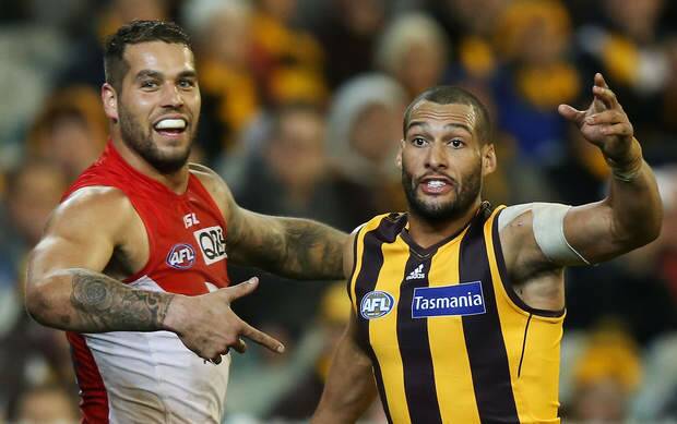 Lance Franklin of the Swans gestures to Josh Gibson.