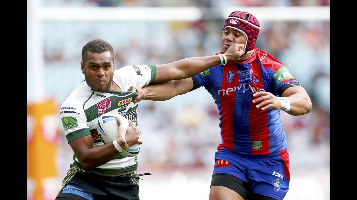 STRONG:   Nemani Valekapa of the Ipswich Jets tries to fend off a tackle during the 2015 State Championship grand final match between Ipswich and the Newcastle Knights.  