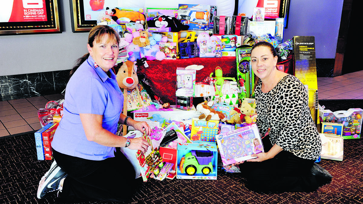 Jenny Harland, from Carrie’s Place, and Reading Cinemas’  Yvette Cavanagh with the toys donated by Maitland people after an appeal for help in the Mercury.
