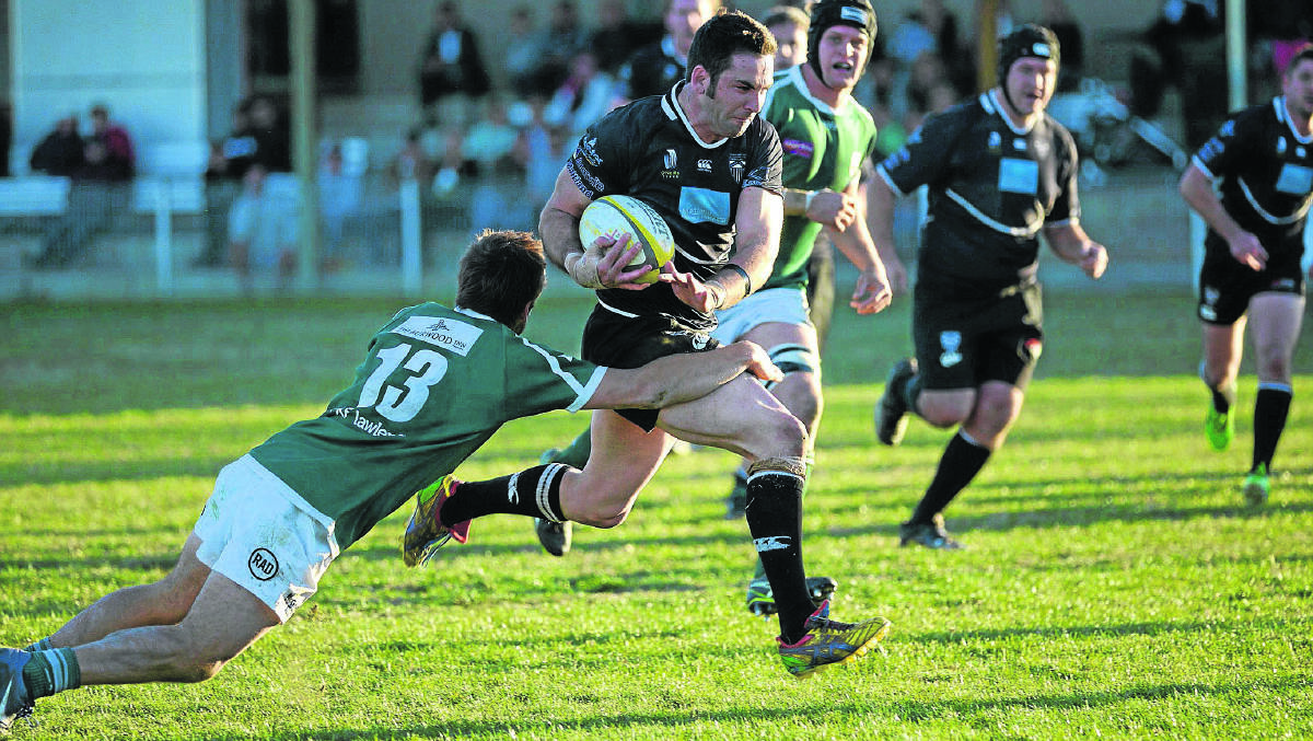Josh Gray breaks through the Merewether Carlton defence to score one of his two tries.