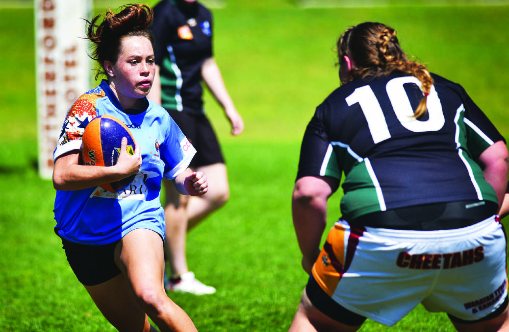 Robyn Draper runs the ball forward during the Maitland Girls Rugby League development  program at Maitland Sportsground.