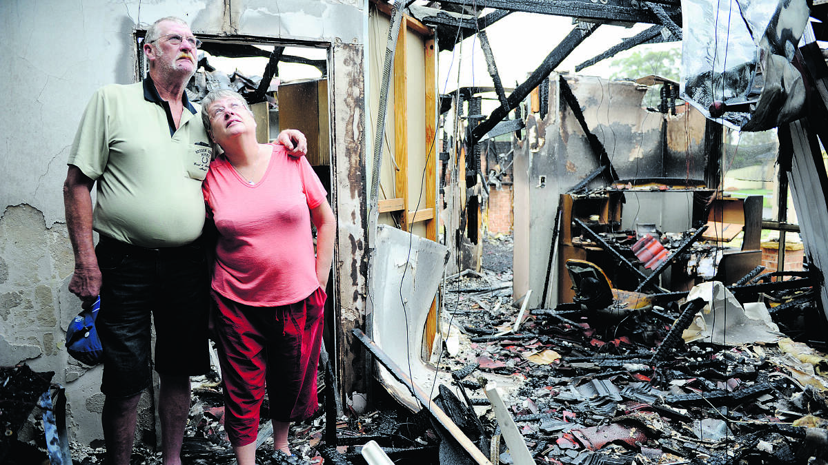 Lindsay and Maria Kirby of Heddon Greta  look over the wreckage of their home yesterday.