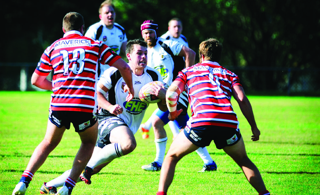 Hinton’s Jacob Watson makes a strong run at the Williamtown defence.  