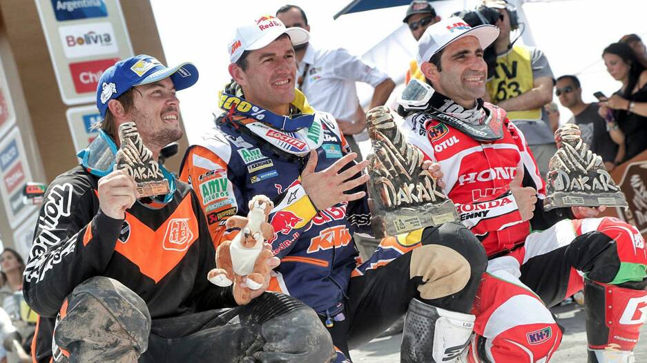 Toby Price (left) celebrates with race winner Marc Coma (centre) and runner-up Paulo Goncalves.