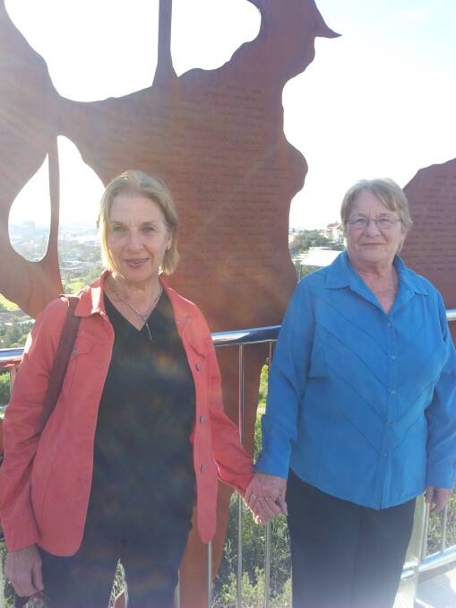 SPECIAL MOMENT: Christine Barrett of Telarah and her sister Patricia share a special moment on the Anzac Memorial Walk.